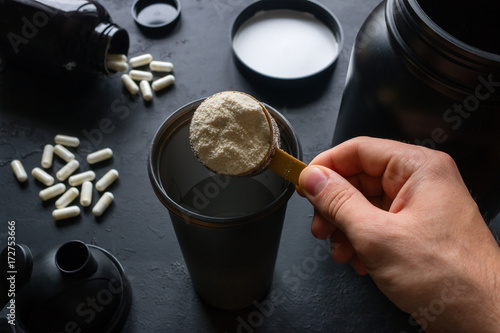 male athlete makes a protein cocktail