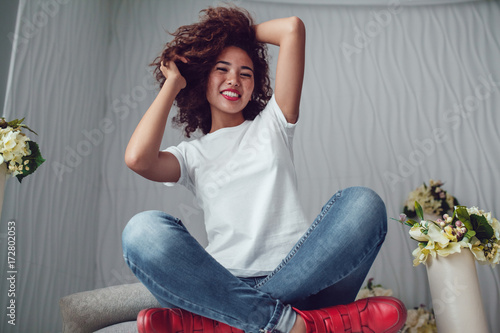 Curly haired girl with freckles in blank white t-shirt. Mock up.