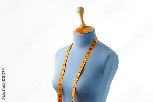 Blue tailor dummy with measuring tape isolated on white.