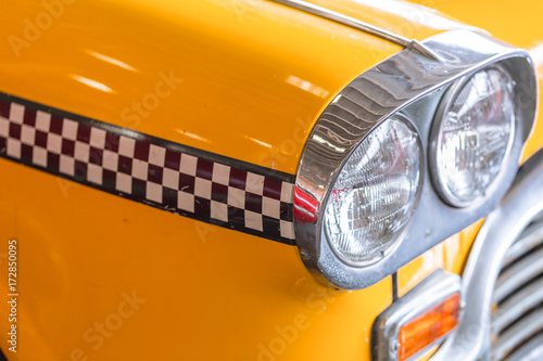 yellow taxi car close up head light for taxi driver background concept