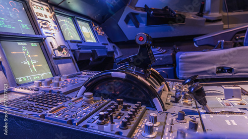 Detailed view of the upper set of switches in a large airliner. Selective focus. Low Light from a plane control cockpit in the dark vintage, detail on the interior cockpit