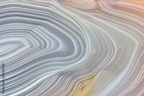 Amazing Banded Agate Crystal cross section as a background. Natural light translucent agate crystal surface, Gray abstract structure slice mineral stone macro closeup