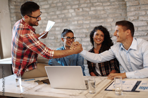  Good news handshake in the office