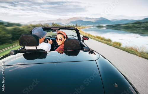 In love couple traveling by cabriolet car