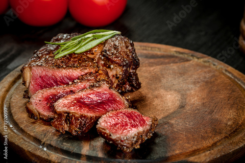 Grill juicy beef steak with salt pepper and rosemary.