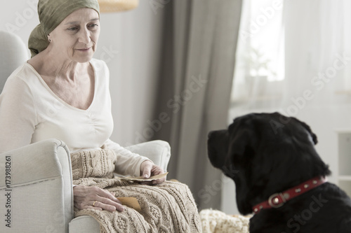 Elderly woman and black dog