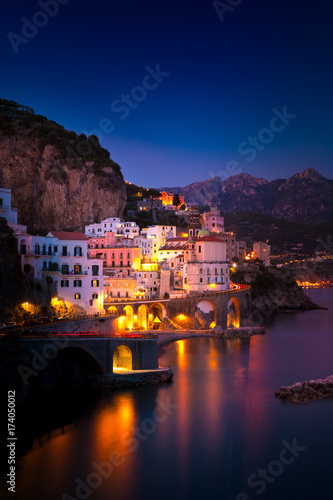 Night view of Amalfi cityscape on coast line of mediterranean sea, Italy