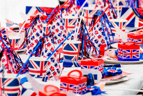 Long tables with red, white and blue party accessories at a Royal event street party