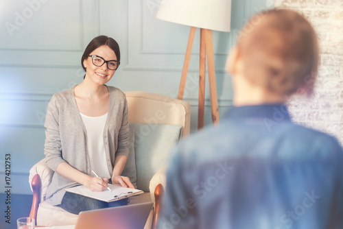 Positive school psychologist going to talk with a teen boy