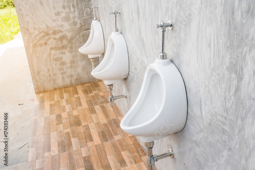 white urinal On The Concrete Wall