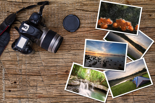 Old camera and stack of photos on vintage grunge wooden background, photography hobby lifestyle concept