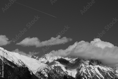 Cloud covered mountain peak in Austrian alps landscape, black and white