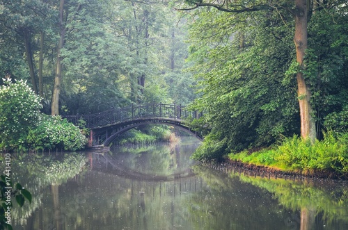 Green park in the morning. Bridge in a beautiful park in Pszczyna, Poland.