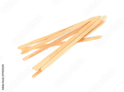 Wooden coffee stirrers on white background