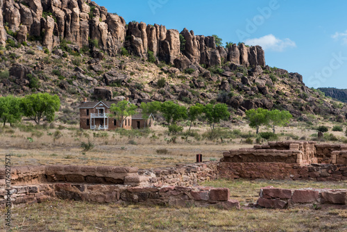 Ruins of fort buildings in the foreground with officer quarters in the background on Fort Davis