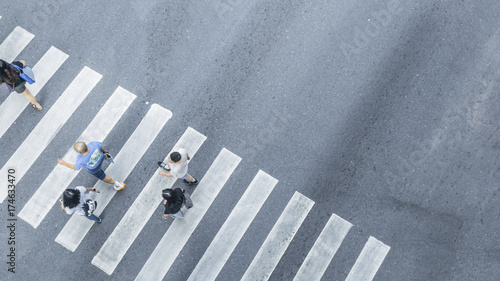 Crowd of people walk on street pedestrian crossroad in the city street ,from top view ,bird eye view.