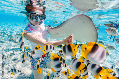 Woman snorkeling with tropical fish