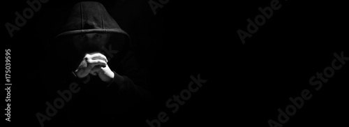 A man in a black hood and fists