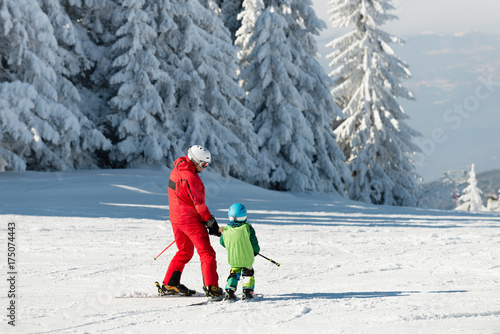Skiing instructor and child on ski slope
