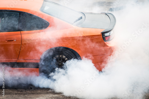 Rear wheel drive super sport car burning tire for warm up before competition to increase type temperature for good traction and grip.