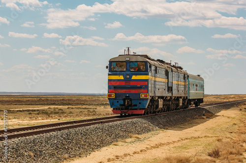 Locomotive train is passing through desert