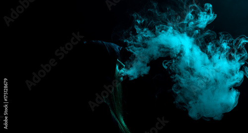 girl exhales blue smoke