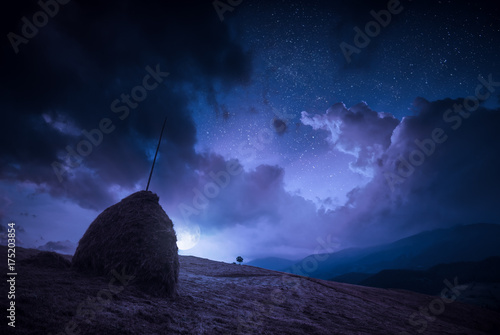 Moonrise with clouds in a night starry sky