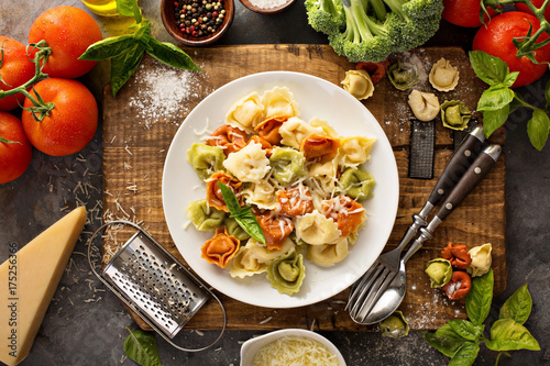 Red, white and green tortellini with vegetables and cheese