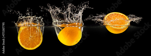 Group of fresh fruits falling in water