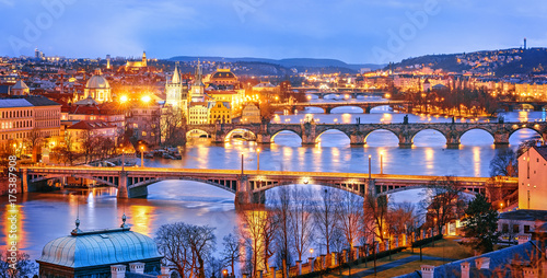 Classic view of Prague at Twilight, panorama of Bridges on Vltava, view from above, beautiful bridges vista. Winter scenery. Prague is famous and extremely popular travel destination. Czech Republic.