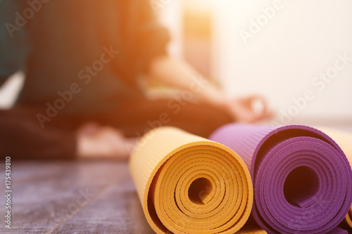 Closeup view of yoga mat and woman on background