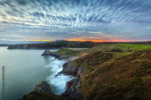 Quilted clouds and a blue hour sunset at Three Cliffs Bay on the Gower peninsula, Swansea, South Wales, UK