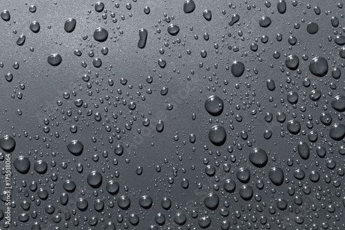 Closeup of raindrops on gray surface, abstract background