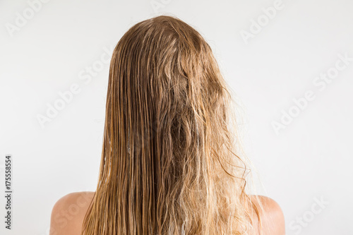 Woman's wet blonde hair after shower on the gray background. Before and after hair brushing with comb. Cares about a healthy and clean hair. Beauty salon concept.