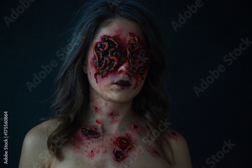 Girl with realistic sores and worms in her eyes. Creative halloween makeup.