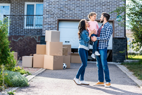 family in front of new house