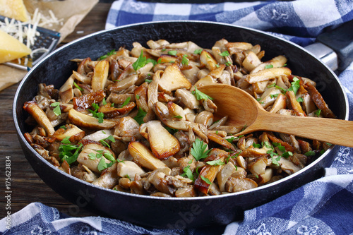 fried porcini with parsley in skillet