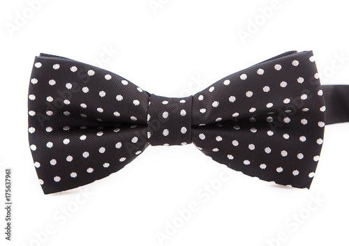 Bow tie accessory for a gentleman. Black with white polka dots on white background