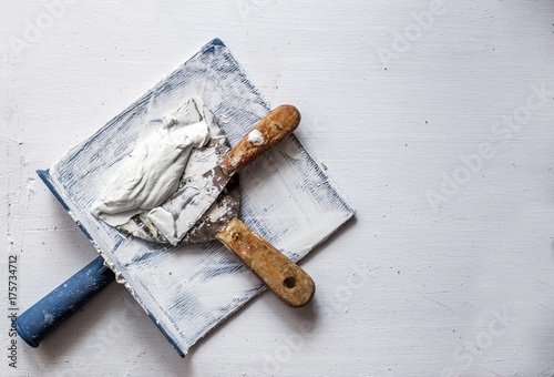 trowel and plastic plate renovate concrete construction building by yourself