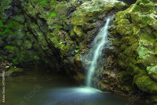 Small forest waterfall in the valley near Csesznek in Hungary