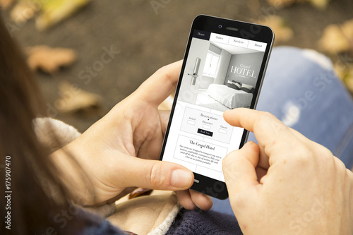 woman with hotel website design phone in the park