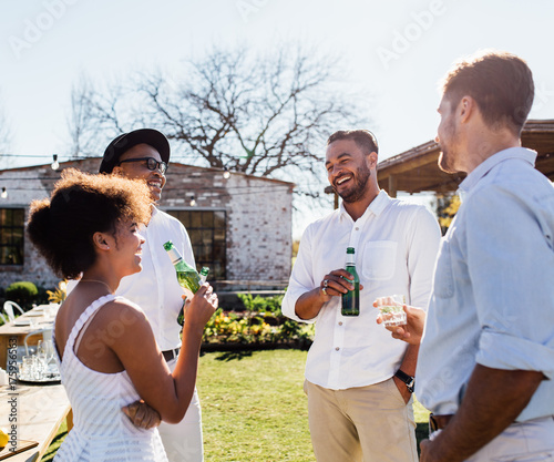 Cheerful group of friends having a party outdoors