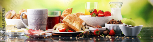 Breakfast served with coffee, orange juice, croissants and strawberry, jam and tea.