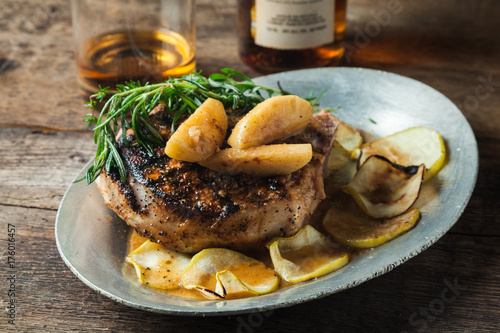 Grilled pork chop with bourbon spiced maple apples served with roasted potatoes