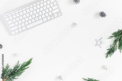 Christmas home office desk with computer, pine branches, christmas decorations. Flat lay, top view, copy space