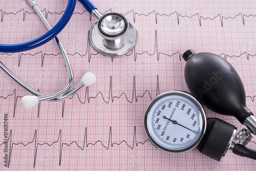 Sphygmomanometer with aneroid gauge and stethoscope with Electrocardiogram paper.