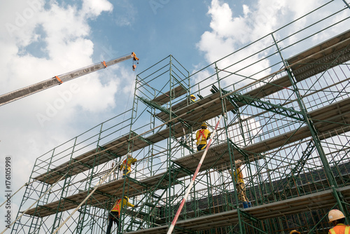 scaffolding in industrial construction during sunset sky background over time job