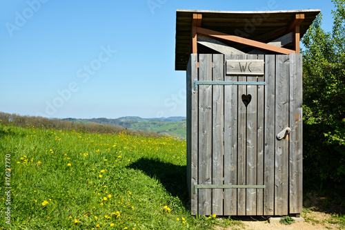 Wooden outhouse in the middle of park