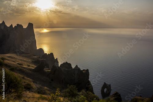 Golden or Devil's Gate at dawn, a famous rock formations near the extinct volcano Karadag Mountain in KaraDag reserve in Crimea A huge rock with a big hole.