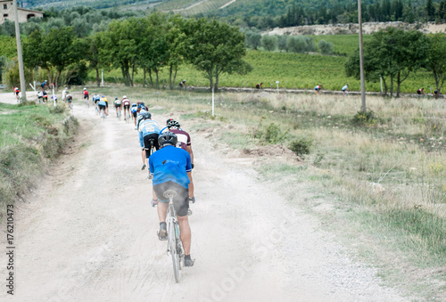 Cyclists during a race on white road of Tuscany